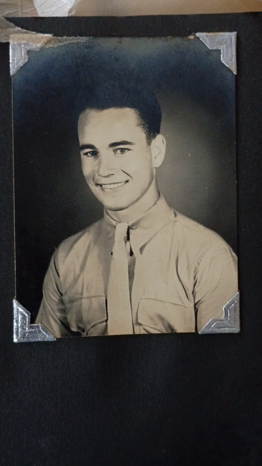 WWII-era military portrait photograph in album — unidentified soldier