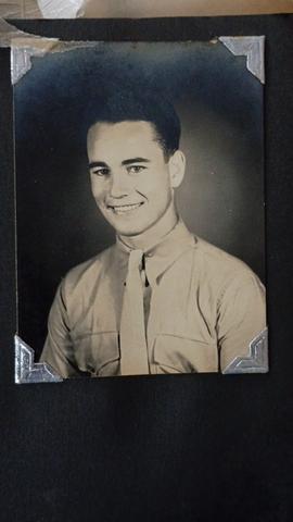 WWII-era military portrait photograph in album — unidentified soldier